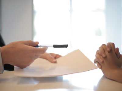 crop businessman giving contract to woman to sign