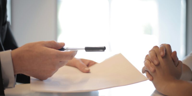 crop businessman giving contract to woman to sign