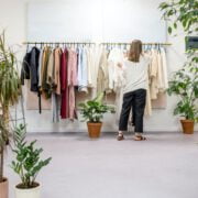 woman fixing clothes on the rack