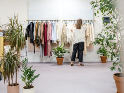 woman fixing clothes on the rack