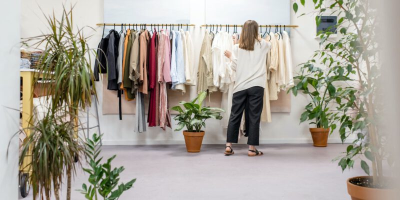 woman fixing clothes on the rack