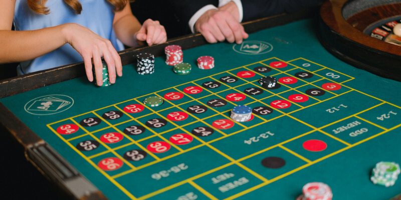 a person holding casino chips